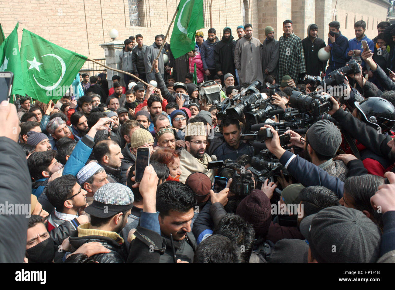 Srinagar, Indian Administered Kashmir. 17th February 2017.All party Hurriyat Conference Chairman and head priest Mirwaiz omar farooq centre adressing a rally at grand mosque after friday prayers .Expressing disappointment over the remarks of the Army Chief General Bipin Rawat.against civilians who indulge in stone pelting during counterinsurgency operations in Kashmir would be treated as anti-nationals and dealt with accordingly.Recently in Bandipora, stone-pelters attacked soldiers when they were about to launch an operation against terrorists holed up in a house. Credit: sofi suhail/Alamy Li Stock Photo