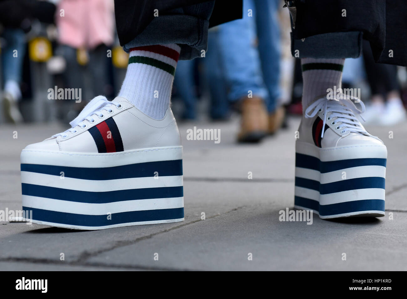 London, UK. 17th Feb, 2017. A girl wearing high platform shoes is one of  the followers of fashion gathered outside the home of London Fashion Week  at 180 The Strand ahead of