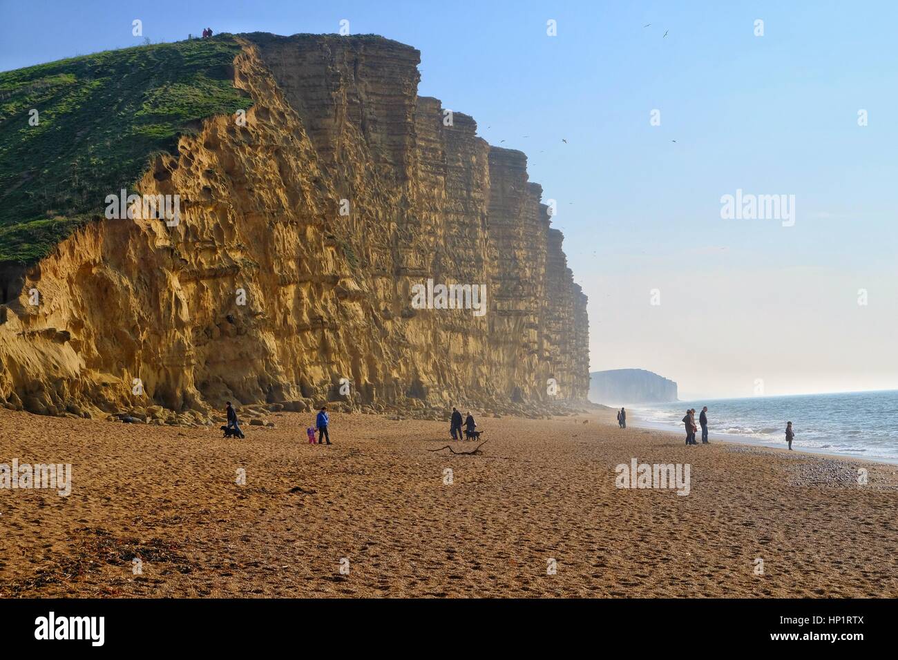 West Bay, Dorset, UK. 18 February 2017. Half term ends and the crowds leave the Dorset coast but the sunshine and unseasonably warm temperatures continue into the weekend. Credit: Tom Corban/Alamy Live News Stock Photo