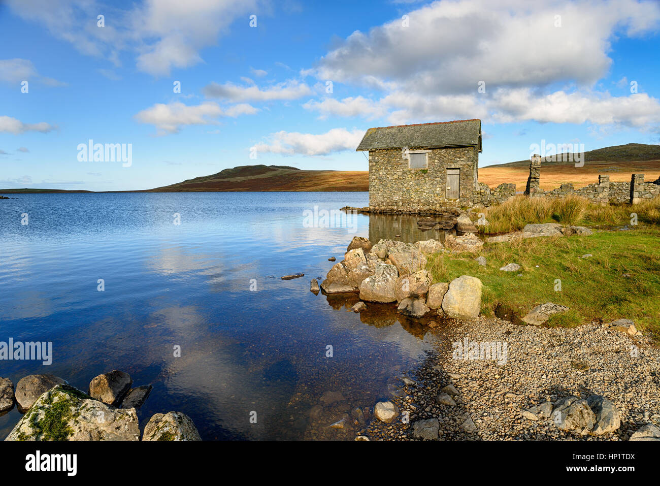 An old stone boat house on the shores of Devoke Water in the Lake Distict in Cumbria Stock Photo