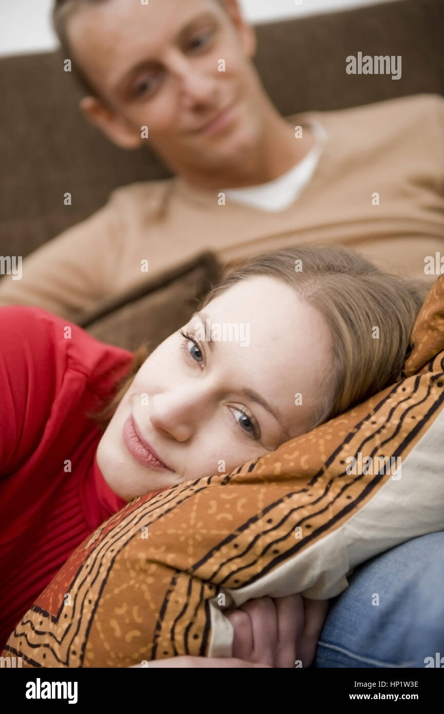 Model release , Junges Paar gemeinsam auf der Couch - young couple on couch Stock Photo
