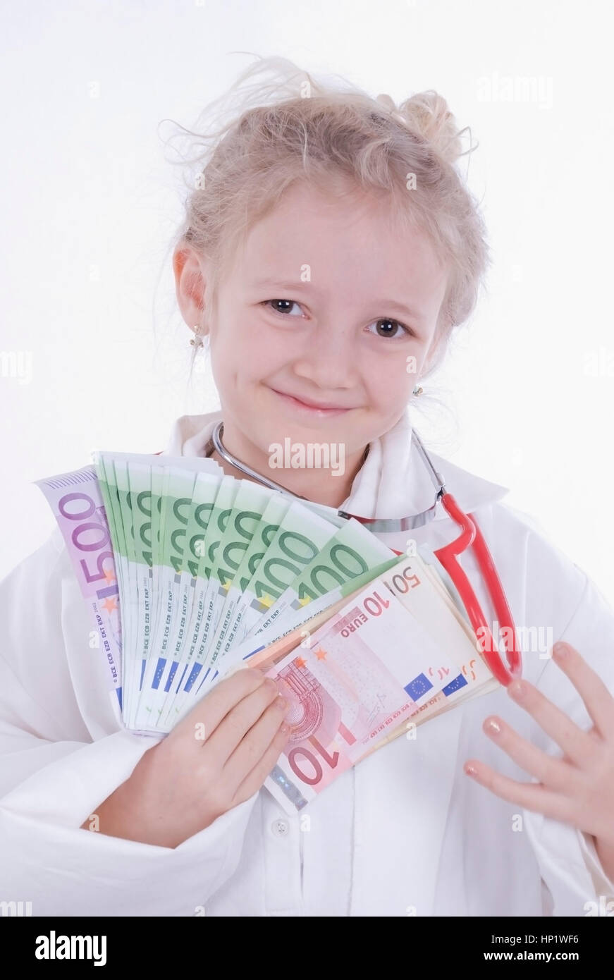 Model release , Maedchen, 7 Jahre, als aerztin mit Geld - girl as a doctor Stock Photo