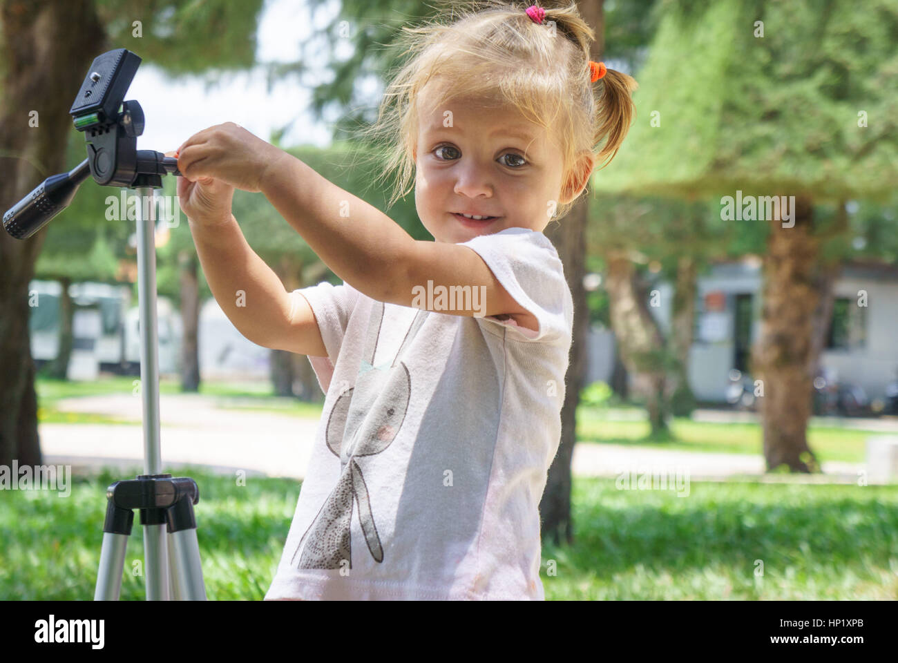 Little Photographer with Professional Tripod, girl playing outdoors Stock Photo Alamy
