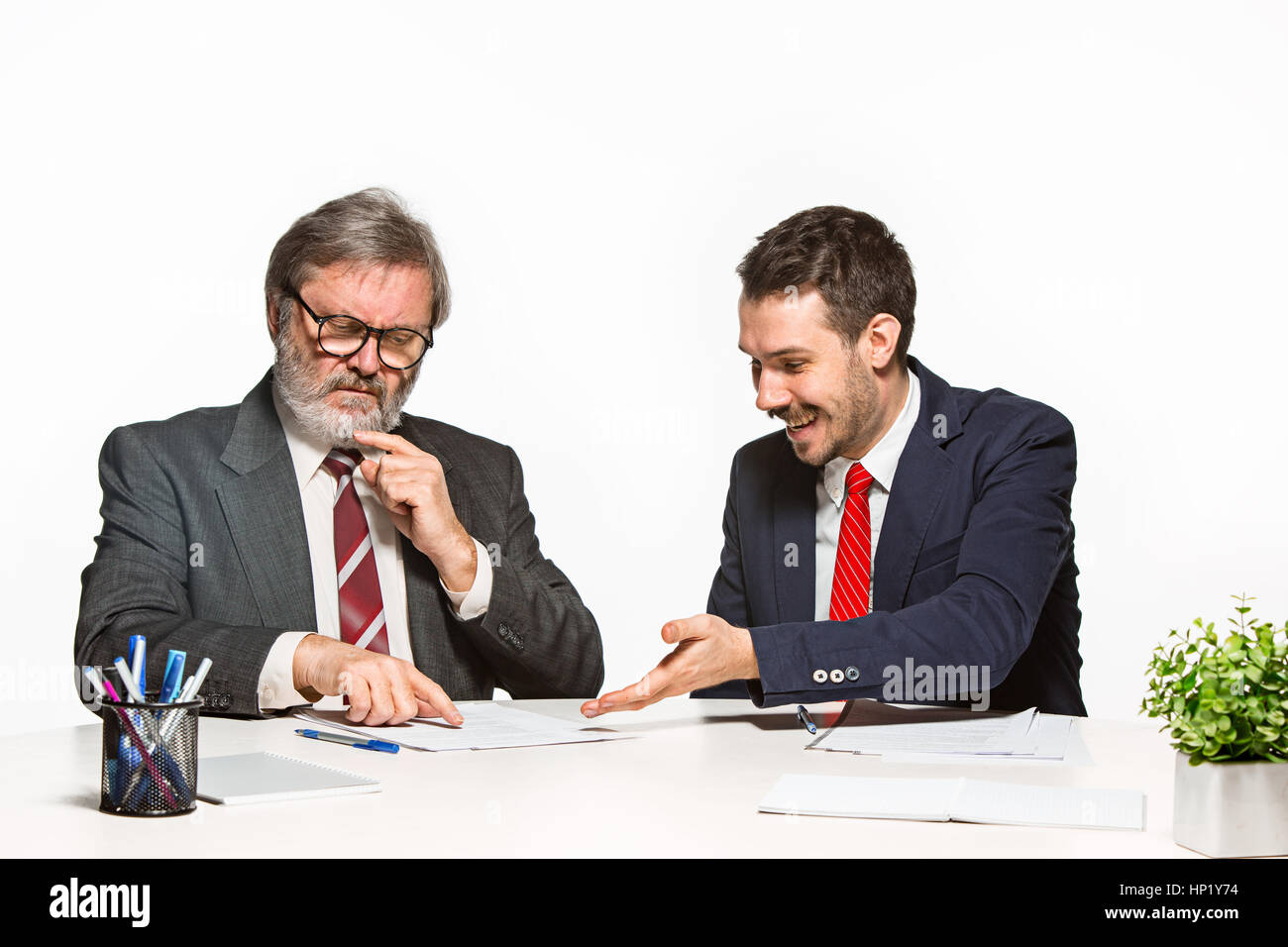 Two Team Members The two colleagues working together at office on white background Stock ...