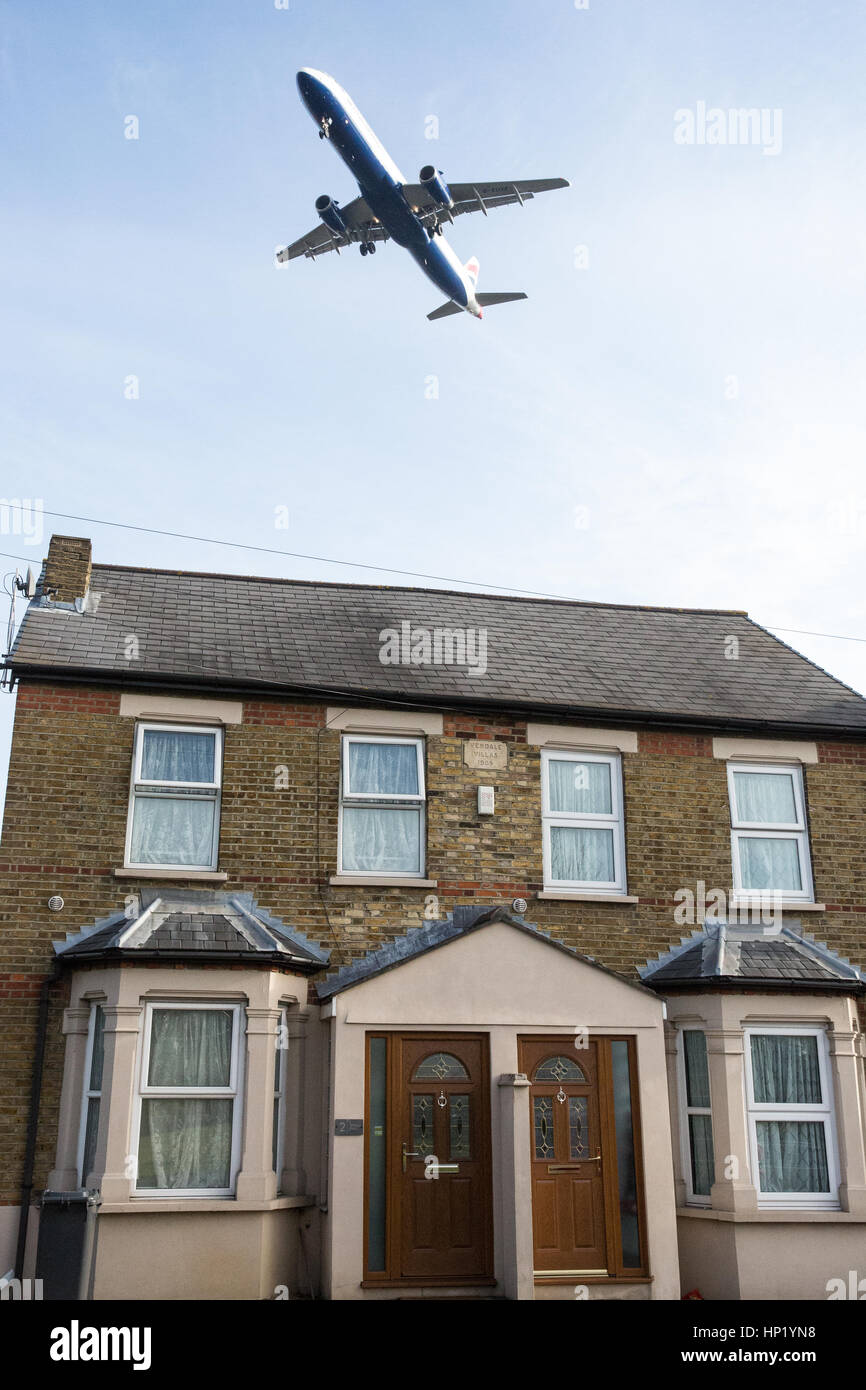 London, UK. An aircraft flies over a house in Hatton Cross on the approach to land at Heathrow Airport. Stock Photo