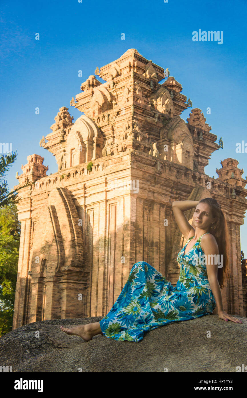 A beautiful girl sitting on the stone Stock Photo - Alamy
