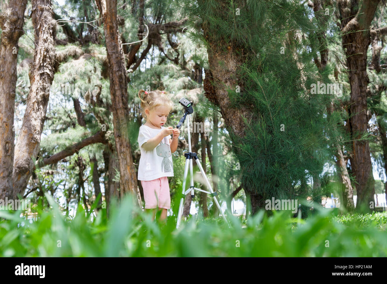 Little Photographer with Professional Tripod, girl playing outdoors Stock Photo Alamy