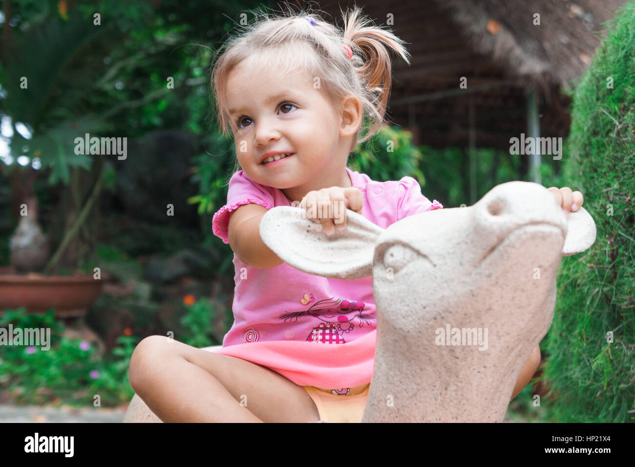 Kid Riding A Deer little girl rides a toy deer Stock Photo - Alamy