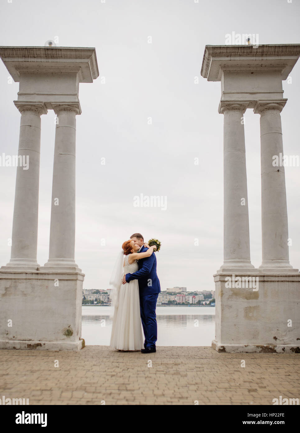 Wedding couple background two columns on lake Stock Photo - Alamy