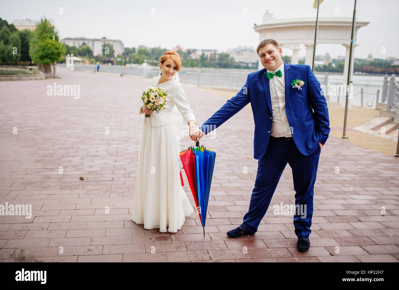 Wedding couple in love under coloured umbrella at rain Stock Photo - Alamy