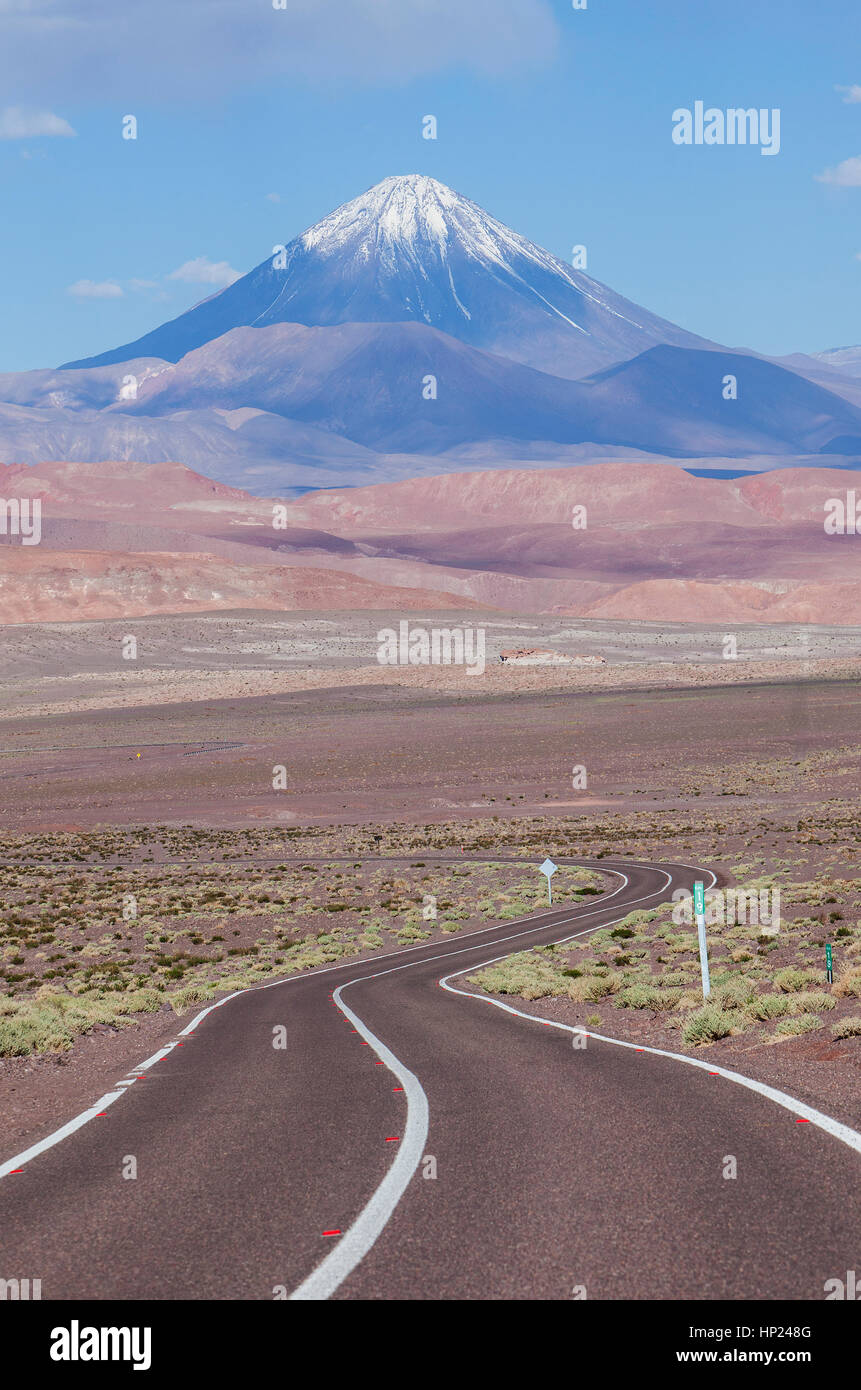 Road to Valle del Arcoiris (Rainbow Valley), in background Licancabur volcano, Atacama desert. Region de Antofagasta. Chile Stock Photo