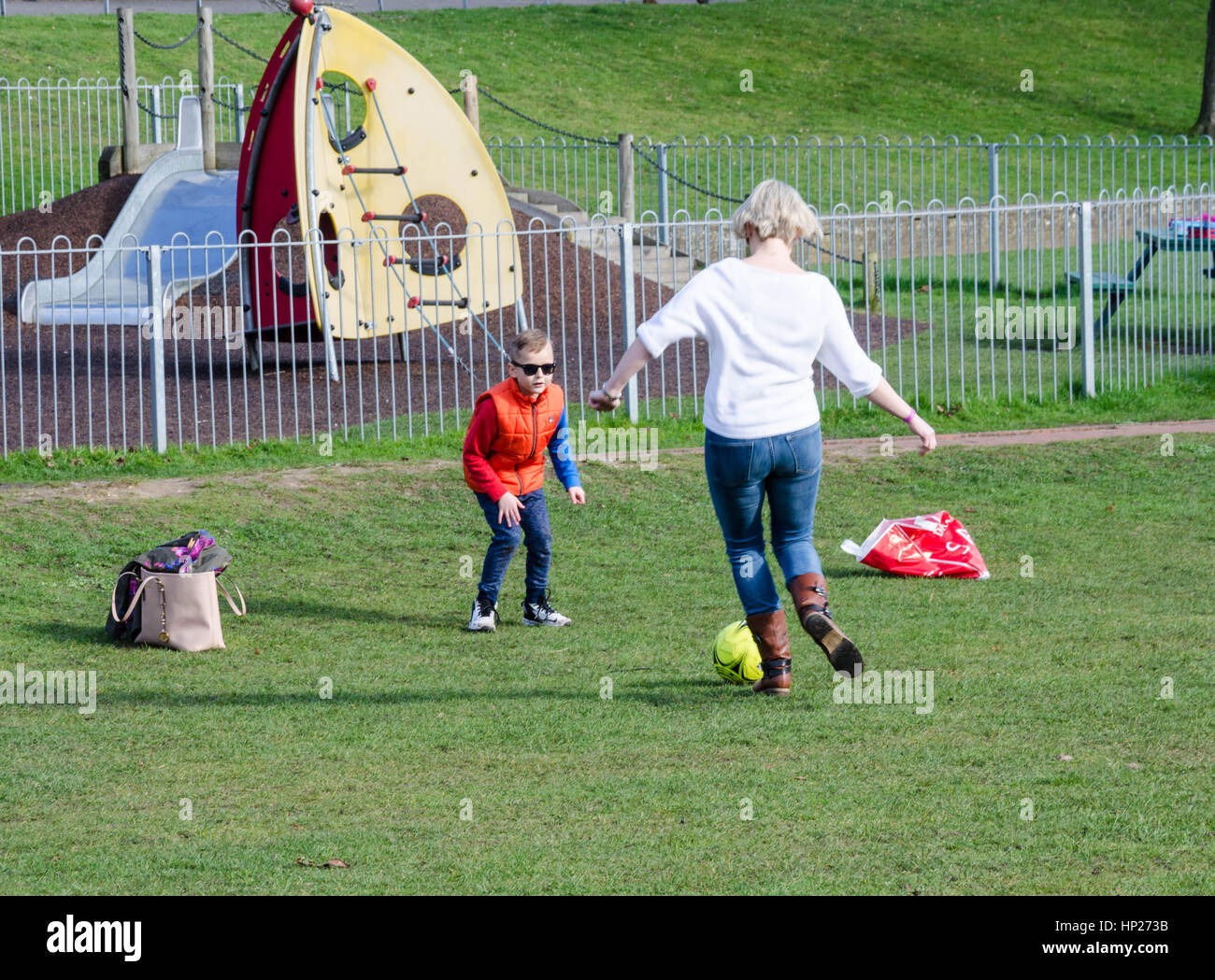 A mother and son play football in the park. Stock Photo