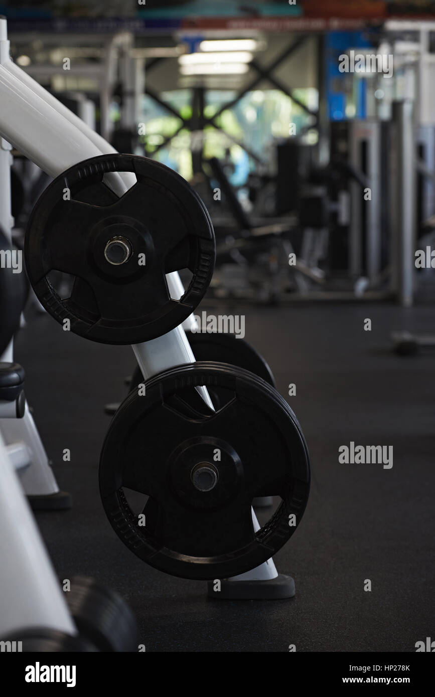 Fintess gym club with heavy weights  equipment. Modern gym for exercise Stock Photo