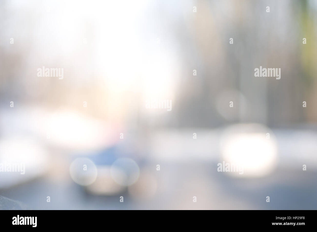 Abstract background with blurry buildings, street signs and cars in ...