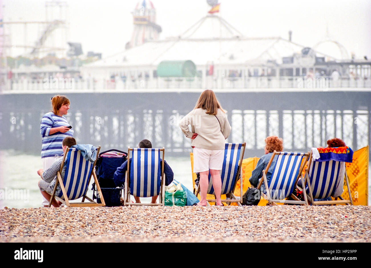 Family enjoying a spring day out on Brighton beach Stock Photo - Alamy