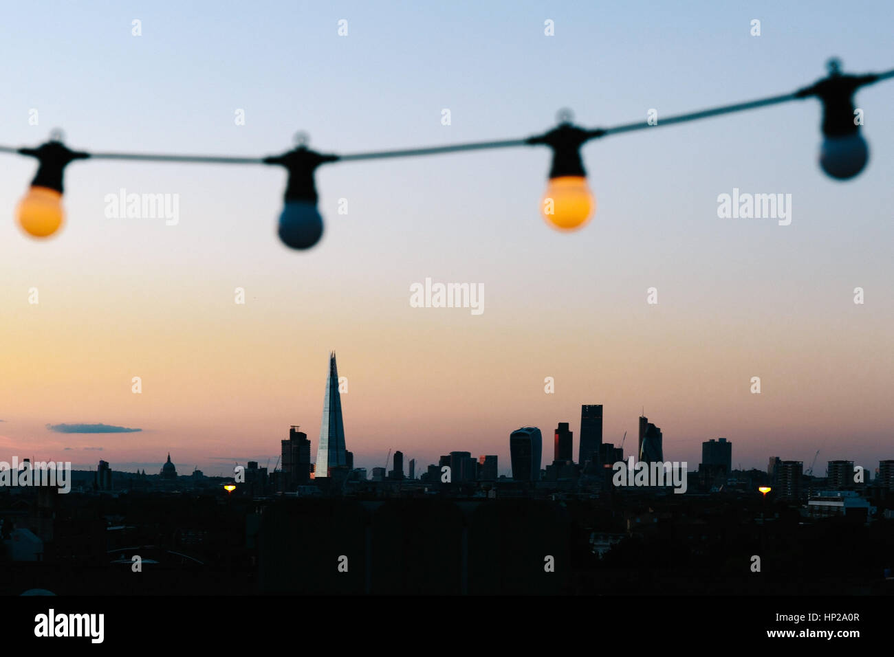 View of London skyline silhouette from an outdoor cinema party at