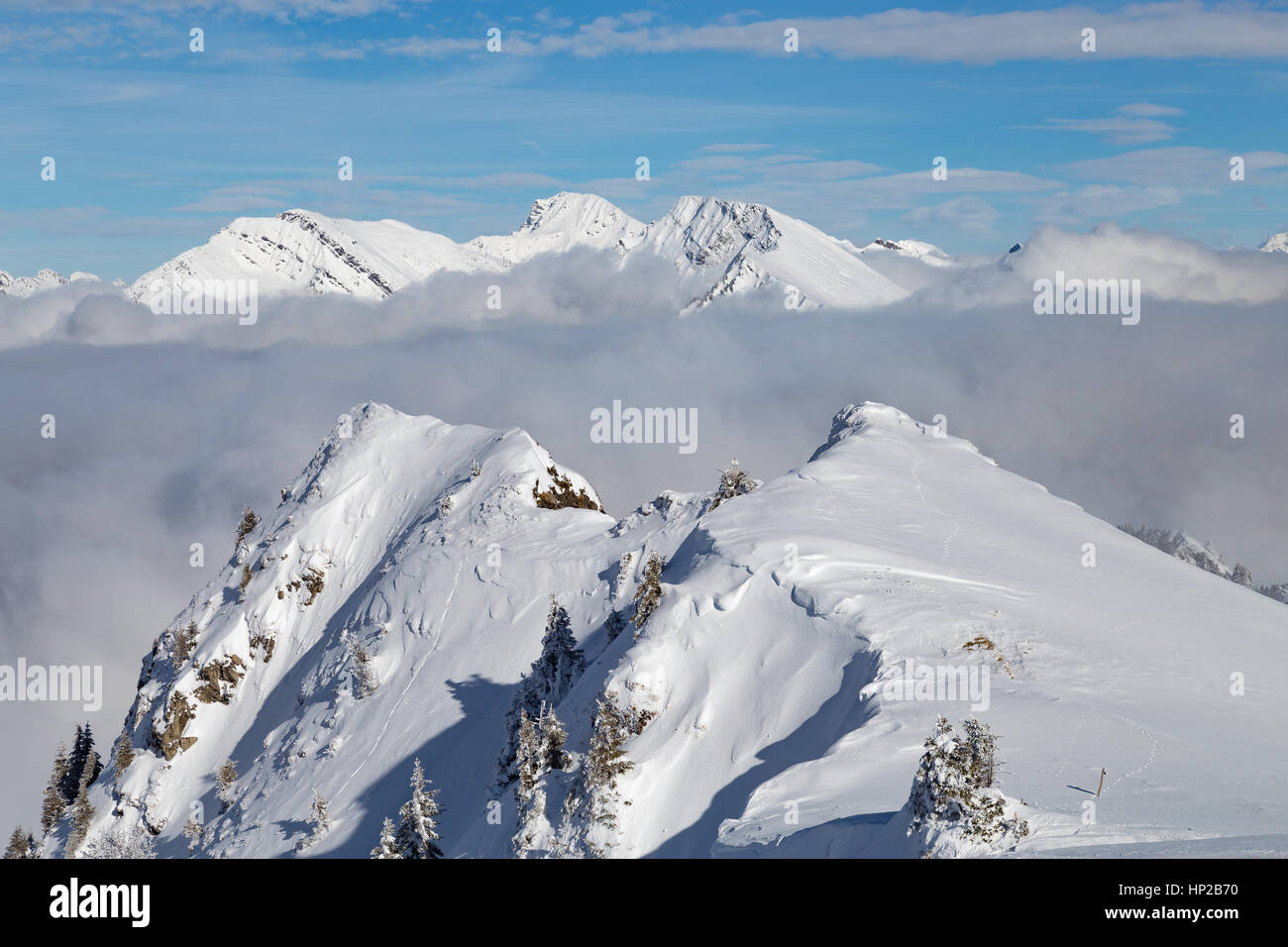 Mountains covered with snow and clouds and trees in the Alps Stock ...