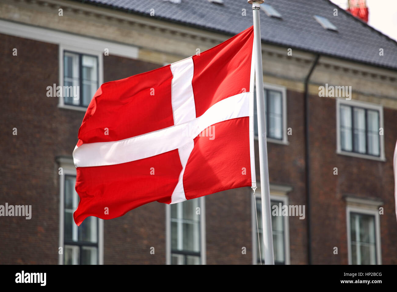 Waving Danish flag on the mast in Copenhagen, Denmark Stock Photo
