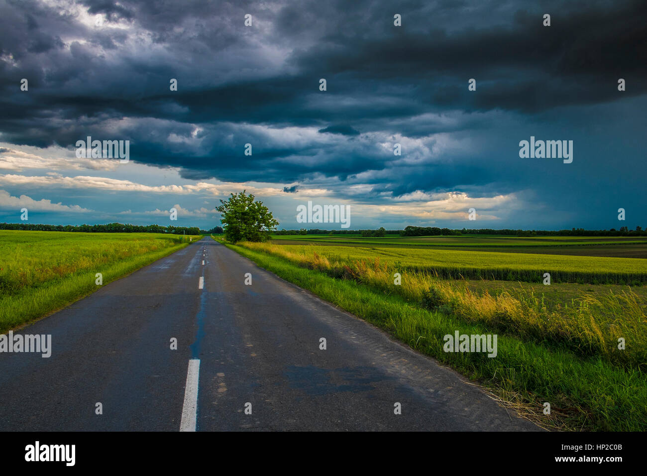 Stormy clouds over asphalt road Stock Photo - Alamy