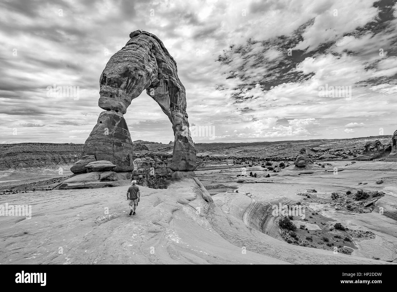 Adventurer hiking to Delicate Arch at Arches National Park Utah. Black and White Landscape photography Stock Photo
