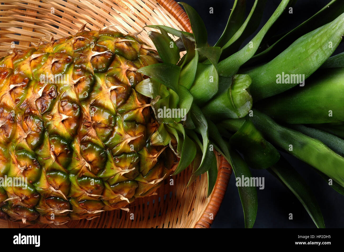 pineapple in a wicker basket Stock Photo - Alamy