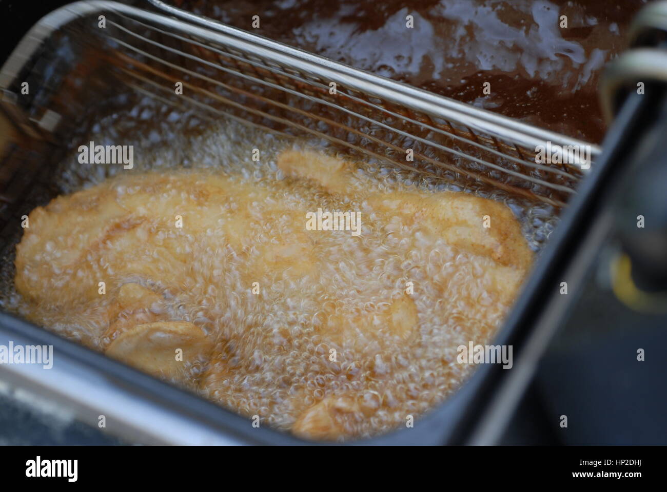 dep frier boiling with fish Stock Photo