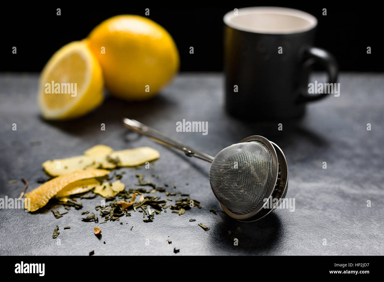 Green tea with lemon zest, black background Stock Photo Alamy