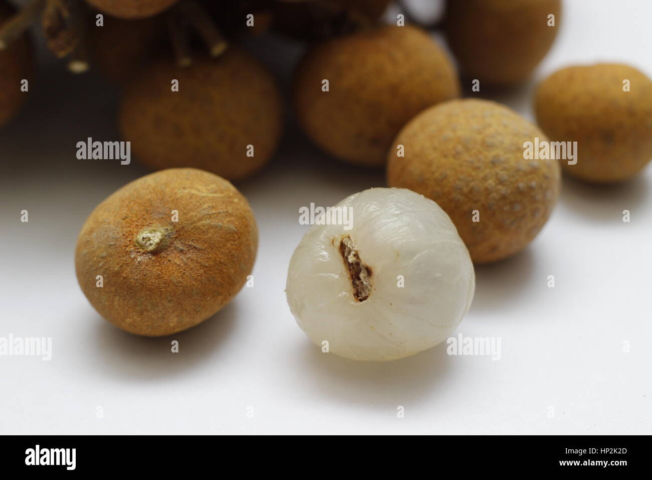 longan fruit, peeled to reveal the white flesh inside. Dimocarpus longan. Stock Photo