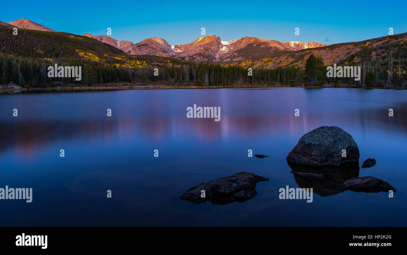 A Beautiful View of Mountains Reflecting off Sprague Lake Colorado on a Spring Morning Stock Photo