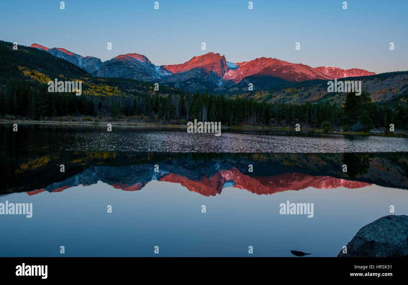 A Beautiful View of Mountains Reflecting off Sprague Lake Colorado on a Spring Morning Stock Photo