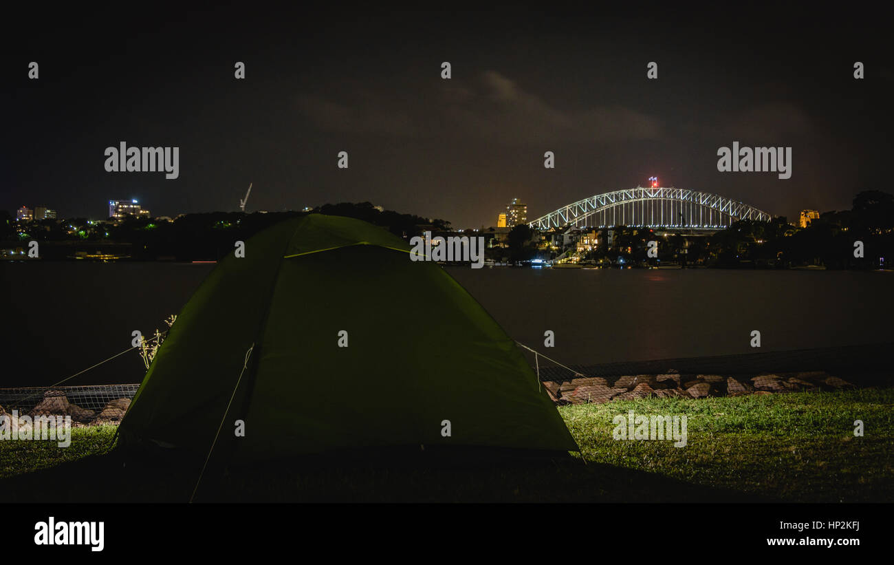 Camping with a view of Sydney harbour bridge at night Stock Photo