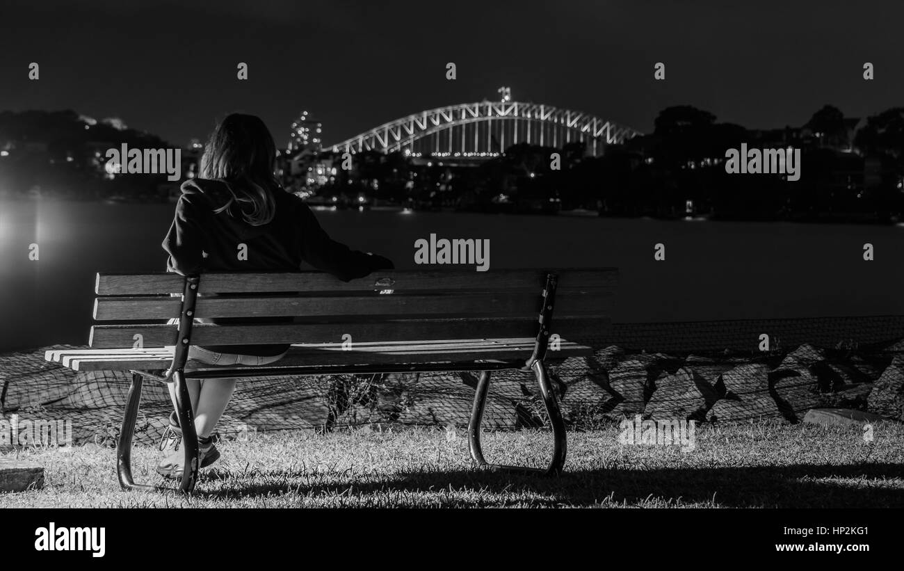 Watching Sydney harbour bridge at night Stock Photo