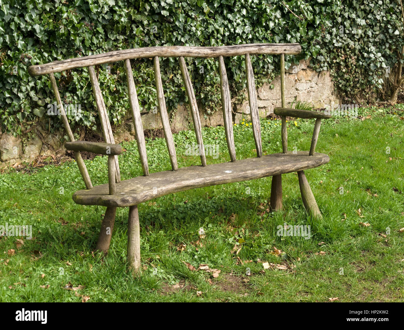 Rustic handmade wooden park bench seat, Ticknall, Derbyshire, England, UK Stock Photo