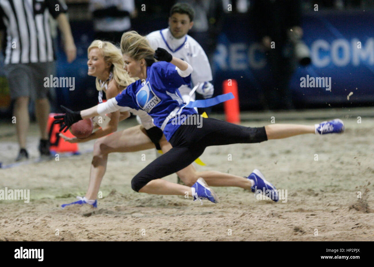 Marisa Miller, (blue uniform) and Brooke Long dive for a pass at the DIRECTV’s Fifth Annual Celebrity Beach Bowl on February 5, 2011 in Dallas, Texas. Photo by Francis Specker Stock Photo