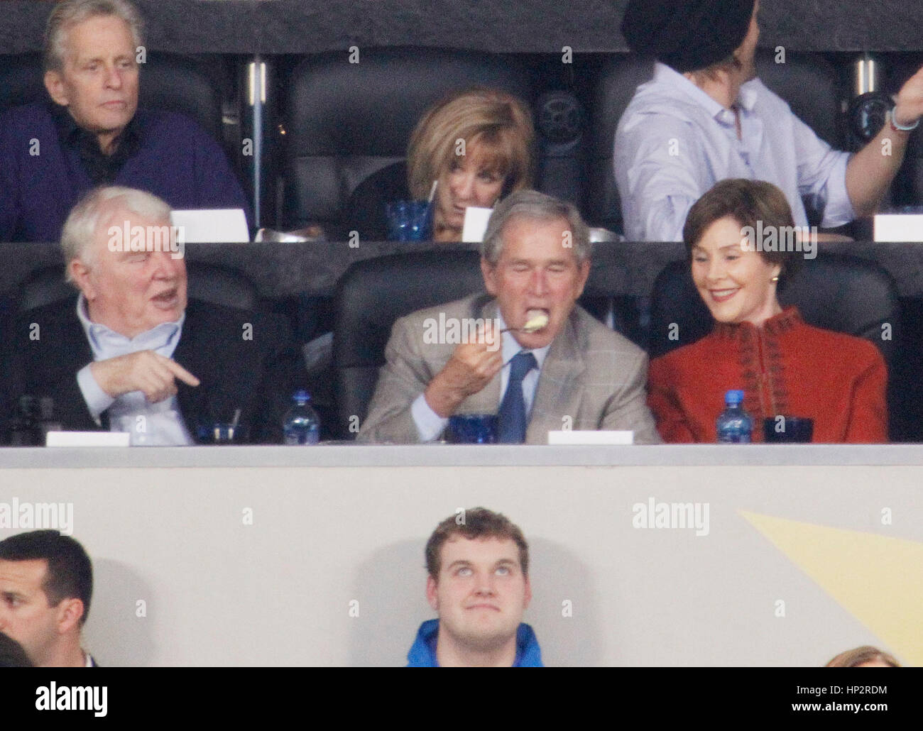 President George W. Bush eats with John Madden, left, his wife, Laura Bush at Super Bowl XLV football game in Arlington, Texas on February 6, 2011. Photo by Francis Specker Stock Photo