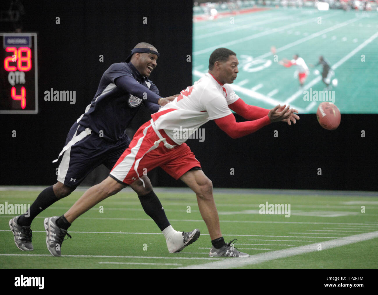 Marcus Allen, right, tries to catch a pass while defended by Derrick Brooks, at the Tazon Latino V flag football game at Super Bowl NFL Experience at the Dallas Convention Center on February 2, 2011 in Dallas, Texas. Photo by Francis Specker Stock Photo