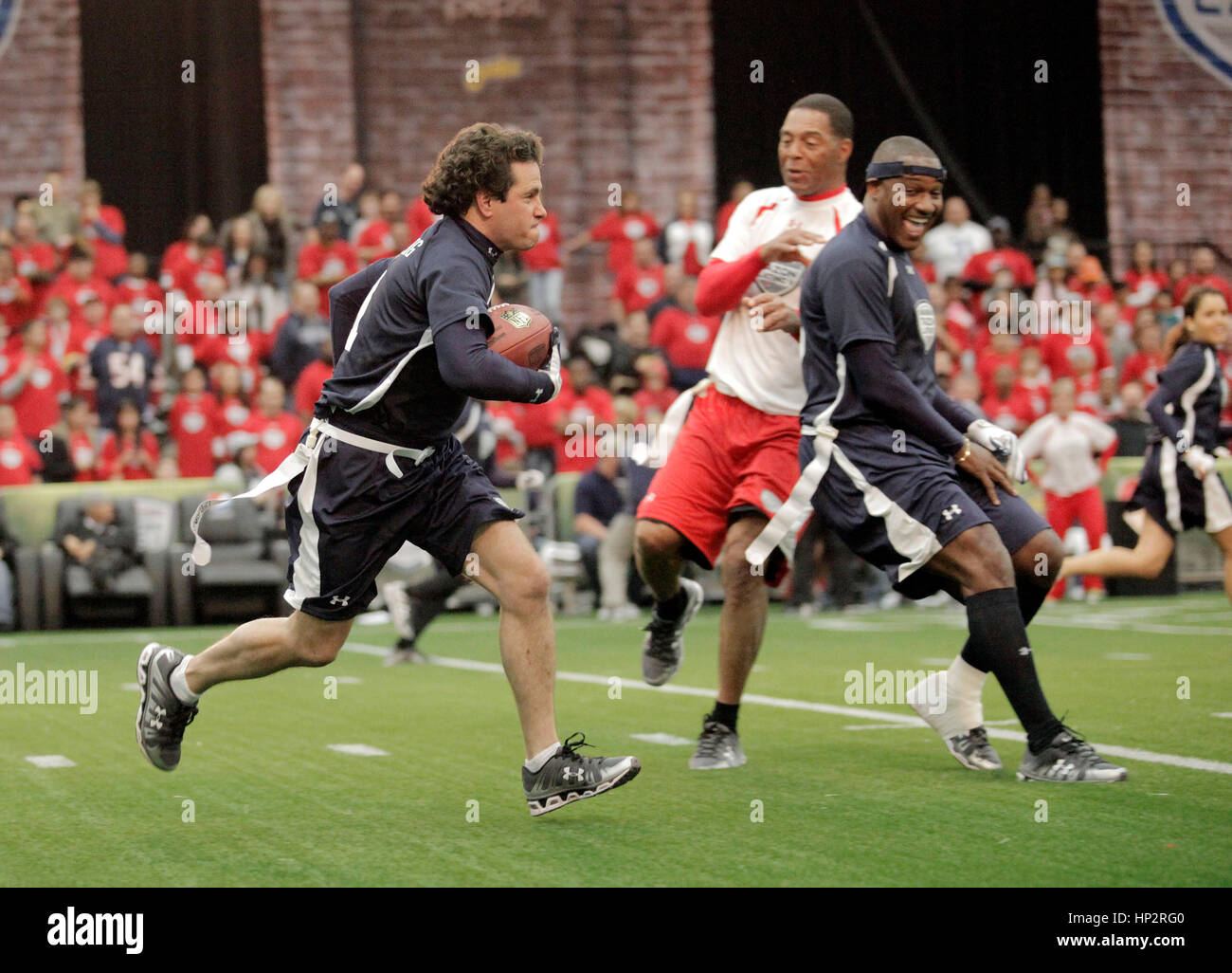Diego Schoening, left, runs with the ball at the Tazon Latino V flag football game at Super Bowl NFL Experience at the Dallas Convention Center on February 2, 2011 in Dallas, Texas. Photo by Francis Specker Stock Photo
