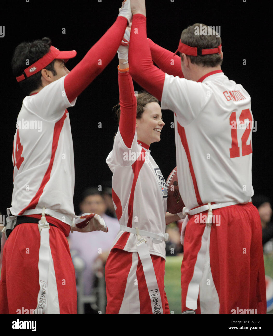 Sarah Ramos, center, celebrates her touch down with teammates Felipe Viel, left, and Rich Gannon at the Tazon Latino V flag football game at Super Bowl NFL Experience at the Dallas Convention Center on February 2, 2011 in Dallas, Texas. Photo by Francis Specker Stock Photo