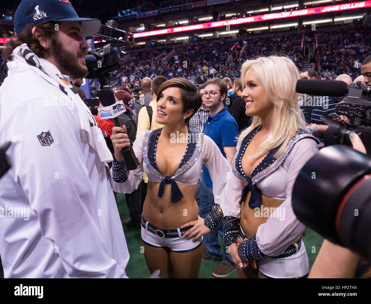 Patriots Danny Aiken, left, is interviewed by Seattle Seahawks cheerleaders on Super Bowl Media Day on January 27, 2015 in Phoenix, Arizona. Photo by Francis Specker Stock Photo