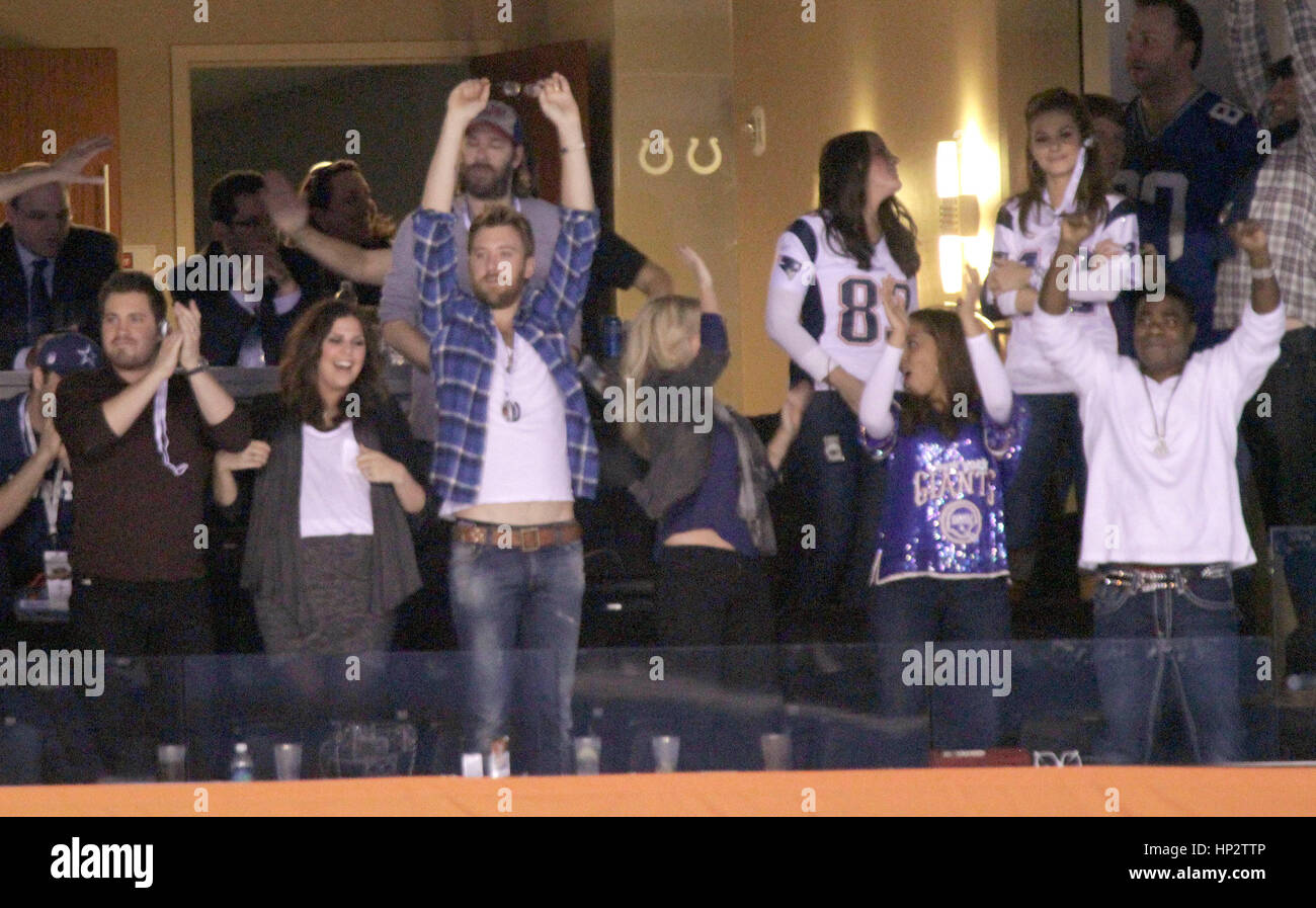 Hillary Scott, Josh Kelley, his wife, Cassie McConnell, and Megan Wollover, and her husband Tracy Morgan, far right, watch the game from a luxury suite during Super Bowl XLVI in Indianapolis, Indiana on February 5, 2012 Photo by Francis Specker Stock Photo