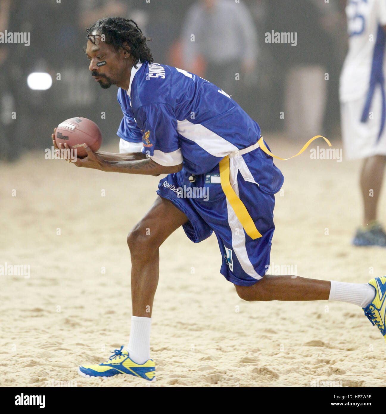 Snoop Dogg catches a football at Directv's Sixth Annual Celebrity Beach Bowl in Indianapolis, Indiana on February 4, 2012. Photo by Francis Specker Stock Photo