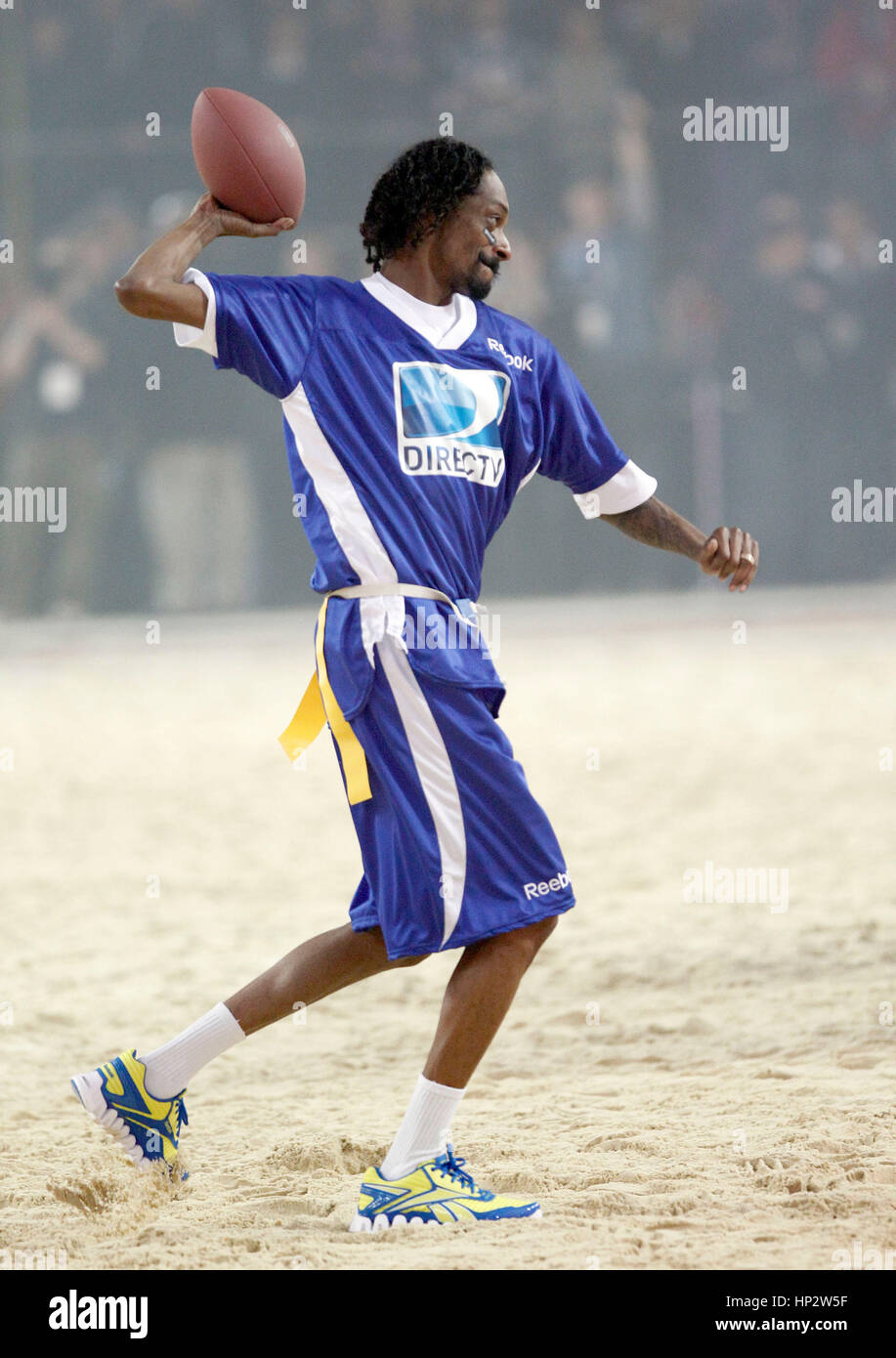 Snoop Dogg throws a football at Directv's Sixth Annual Celebrity Beach Bowl in Indianapolis, Indiana on February 4, 2012. Photo by Francis Specker Stock Photo