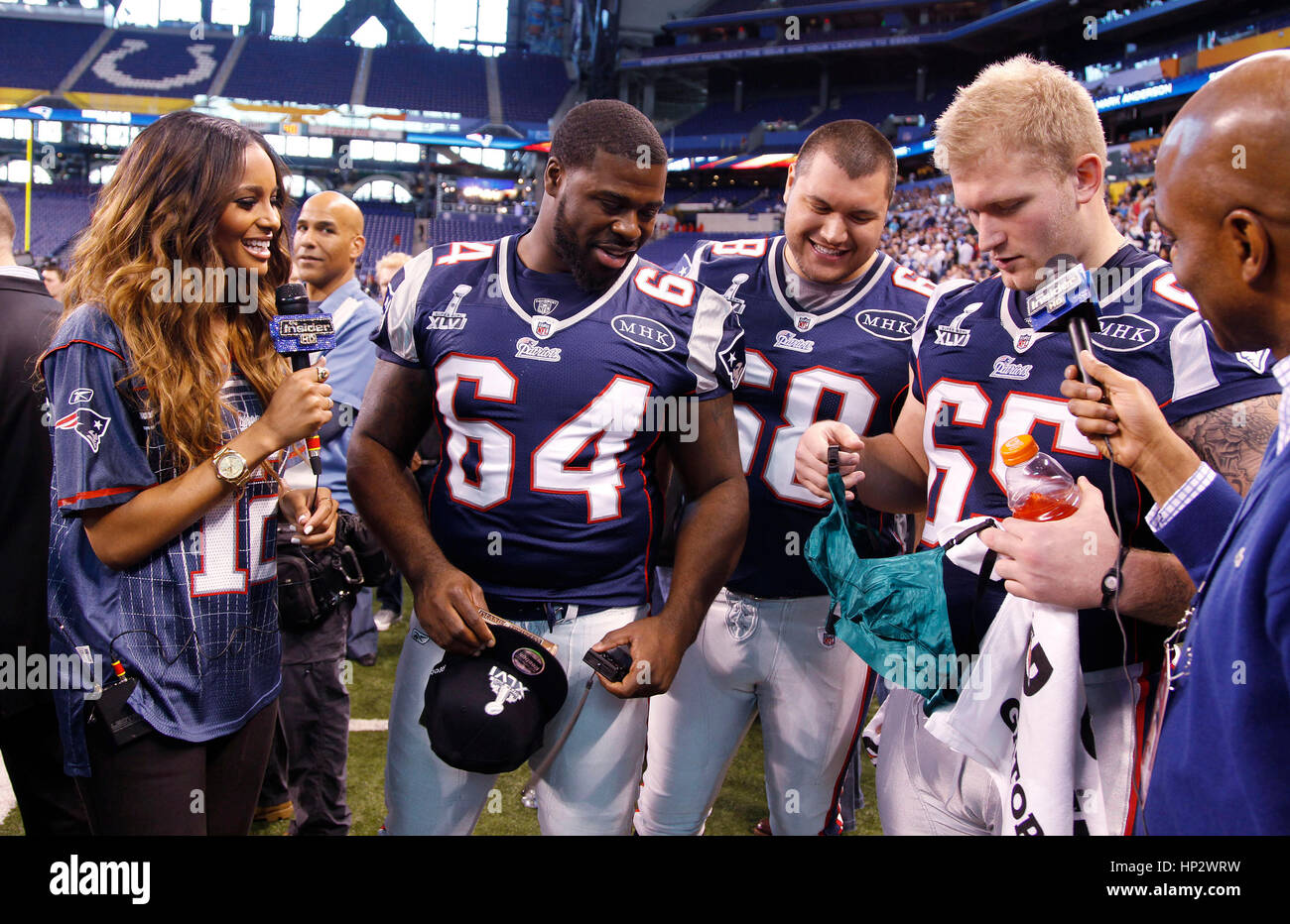 Singer Ciara with New England Patriot players, Donald Thomas (64), Matt Kopa (68) and Nick McDonald (65) who shows off a Madonna bra at the Super Bowl XLVI Media Day in Indianapolis, Indiana on January 31, 2012. Francis Specker Stock Photo