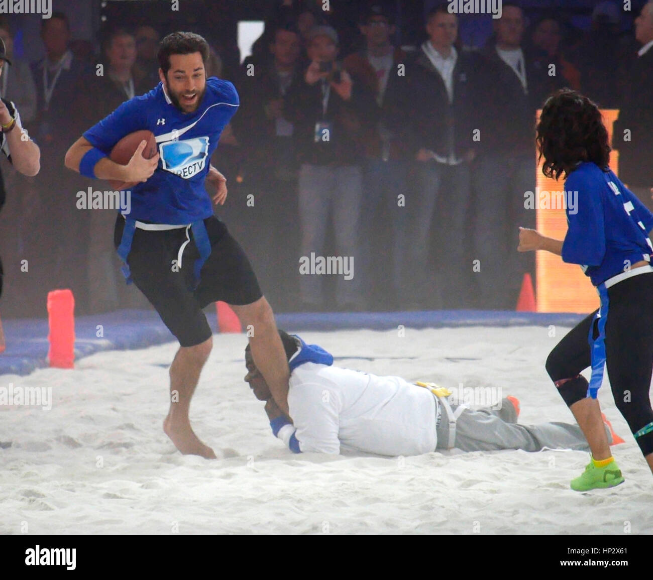 Zachary Levi gets tackled by Tracy Morgan at Directv's 8th Annual Celebrity Beach Bowl on February 1, 2014 in New York, NY. Photo by Francis Specker Stock Photo