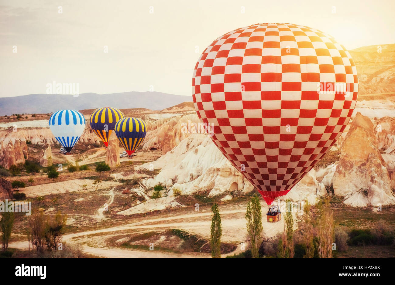 Hot air balloon flying over rock landscape at Turkey. Cappadocia Stock ...
