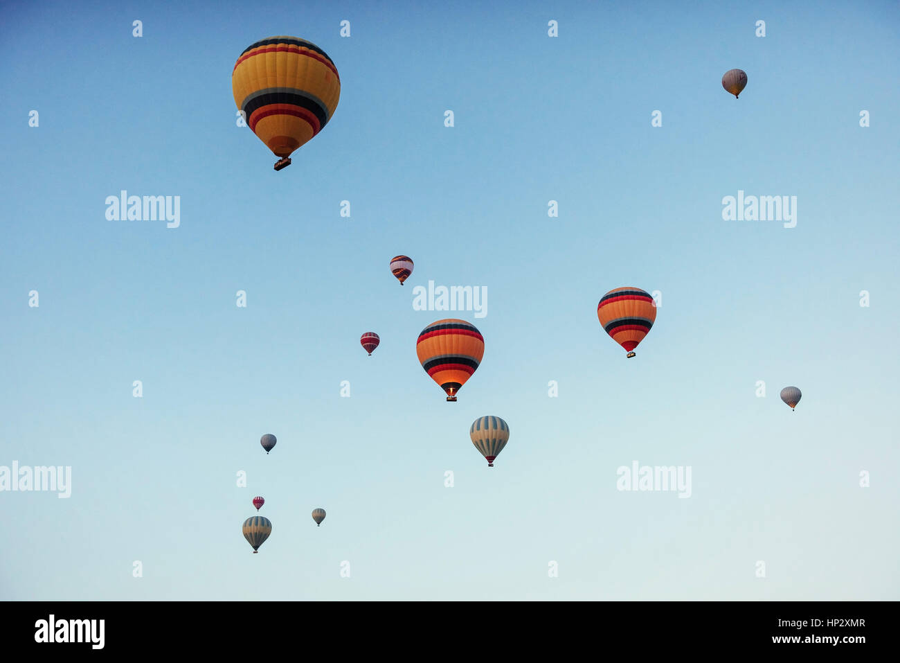 group of colorful hot air balloons against a blue sky Stock Photo - Alamy