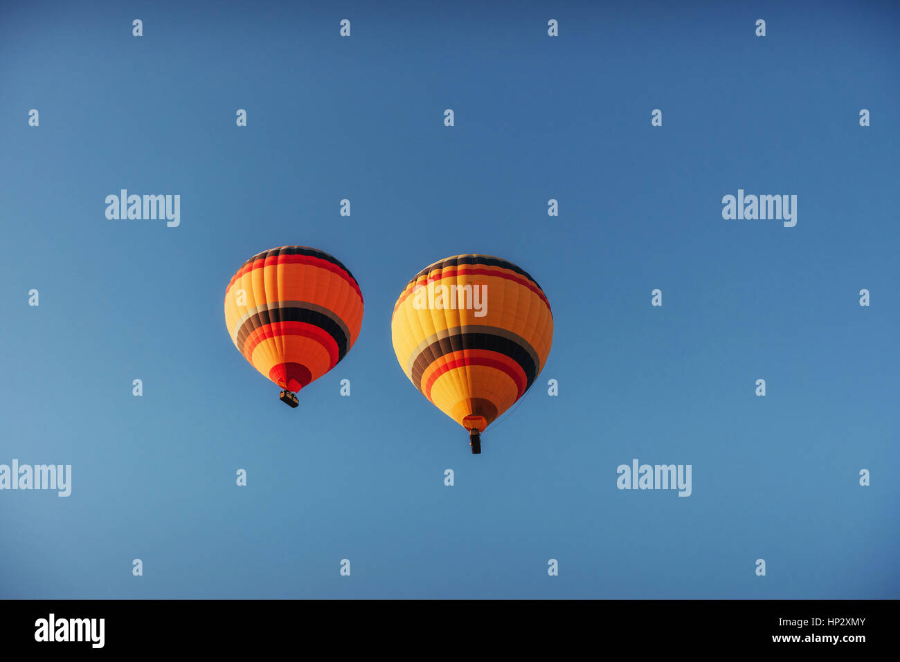 group of colorful hot air balloons against a blue sky Stock Photo - Alamy