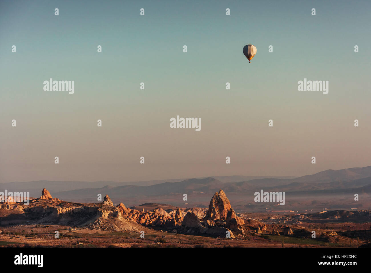 Hot air balloon flying over rock landscape at Cappadocia Turkey Stock ...