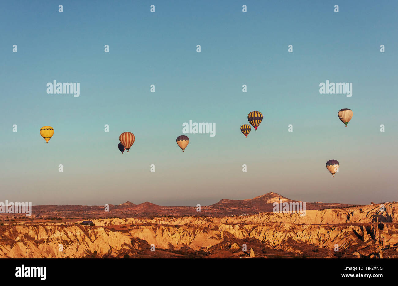 Hot air balloon flying over rock landscape at Cappadocia Turkey Stock ...