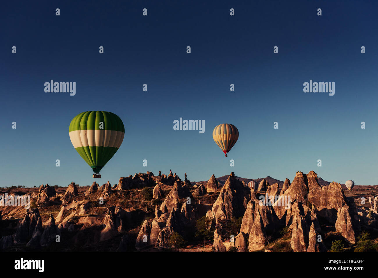 Hot air balloon flying over rock landscape at Cappadocia Turkey Stock ...